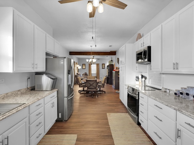 kitchen with hanging light fixtures, white cabinets, stainless steel appliances, and wood-type flooring