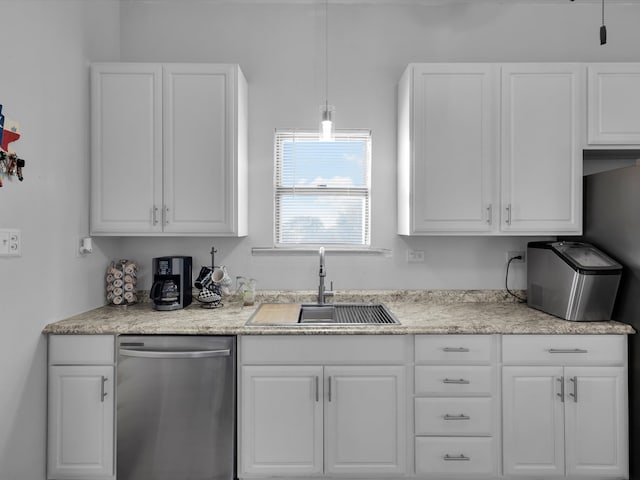 kitchen with stainless steel dishwasher, white cabinetry, sink, and hanging light fixtures