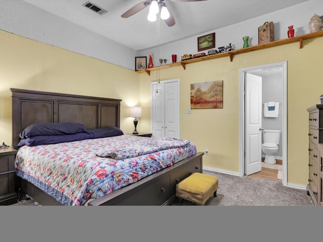 bedroom with light carpet, a closet, ceiling fan, and ensuite bathroom