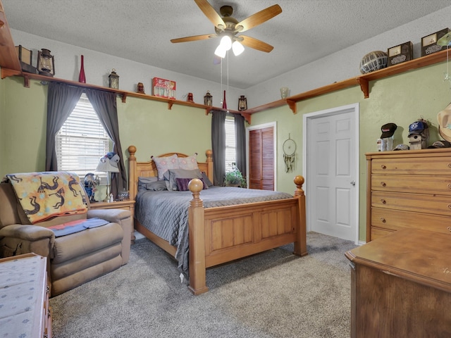 carpeted bedroom with a textured ceiling and ceiling fan