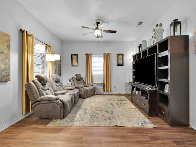 living room with hardwood / wood-style floors and ceiling fan