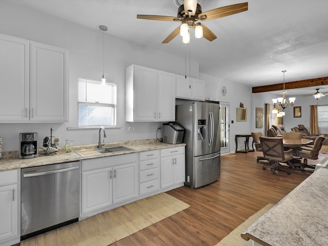 kitchen with sink, white cabinets, stainless steel appliances, and light hardwood / wood-style floors