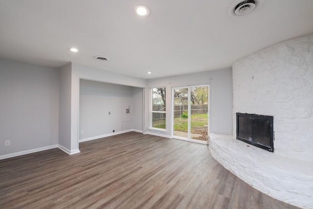 unfurnished living room featuring a fireplace and hardwood / wood-style floors