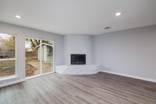 unfurnished living room with wood-type flooring and a fireplace