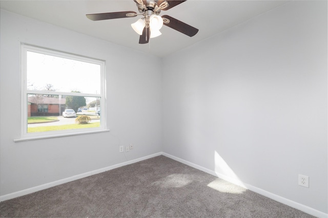 carpeted spare room with ceiling fan