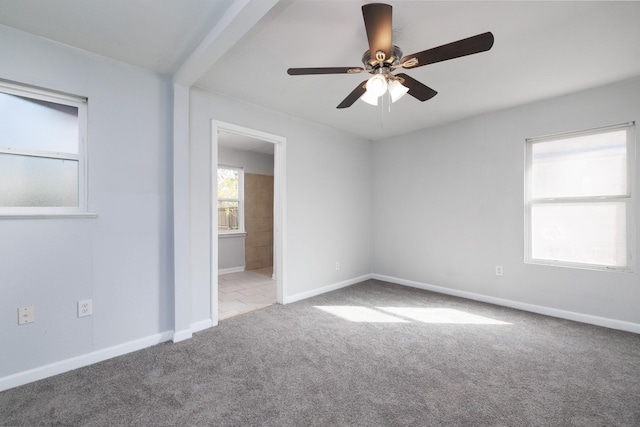 unfurnished room with light carpet and ceiling fan