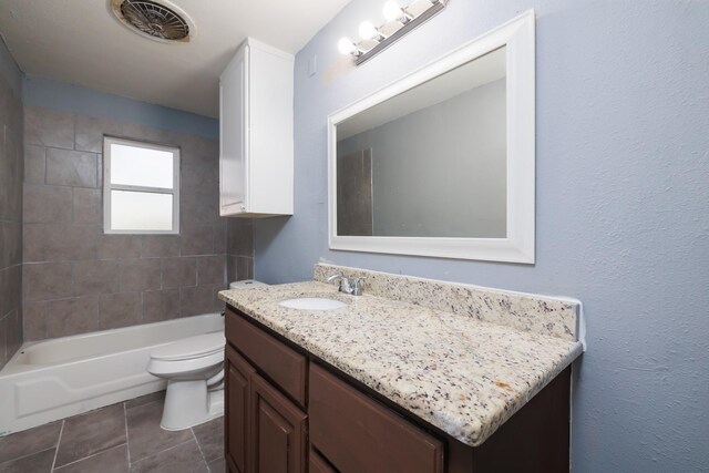 bathroom featuring tile patterned flooring, vanity, and toilet