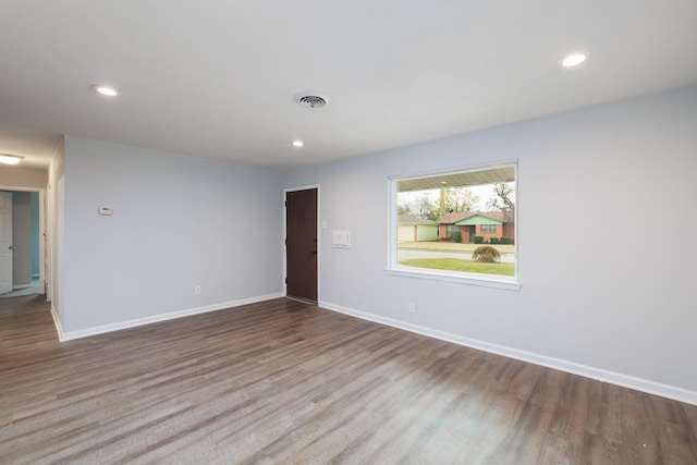 spare room featuring wood-type flooring