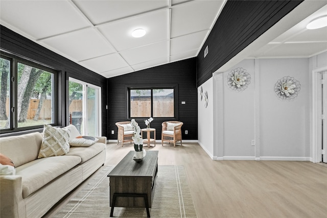 living room with lofted ceiling and light wood-type flooring