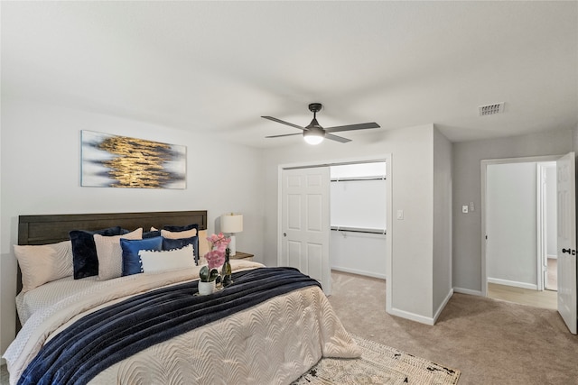 bedroom featuring ceiling fan, a closet, and light colored carpet