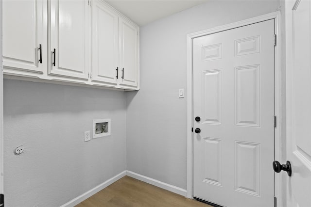 laundry area featuring light hardwood / wood-style flooring, cabinets, and washer hookup