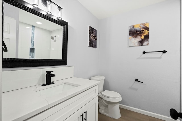 bathroom featuring a shower, vanity, wood-type flooring, and toilet