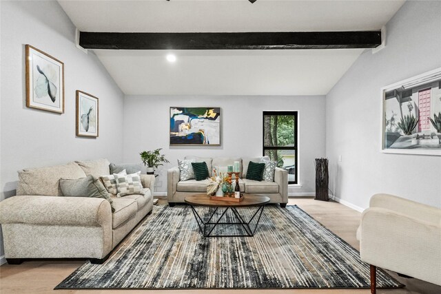 living room featuring vaulted ceiling with beams and light wood-type flooring