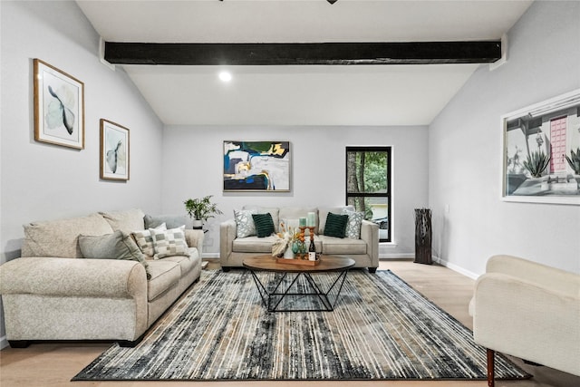 living room with lofted ceiling with beams and light hardwood / wood-style floors