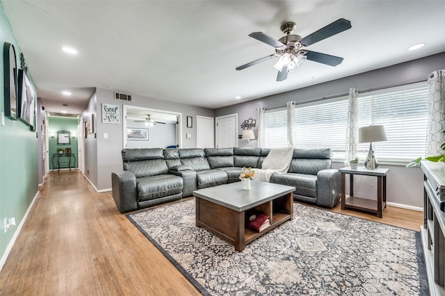 living room featuring ceiling fan and light wood-type flooring