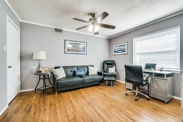 office area featuring crown molding, ceiling fan, light hardwood / wood-style floors, and a textured ceiling