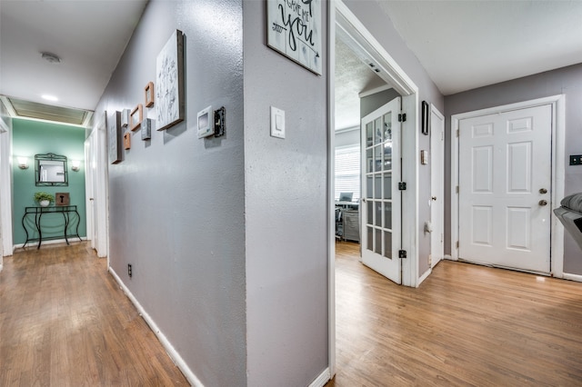 hallway with hardwood / wood-style flooring