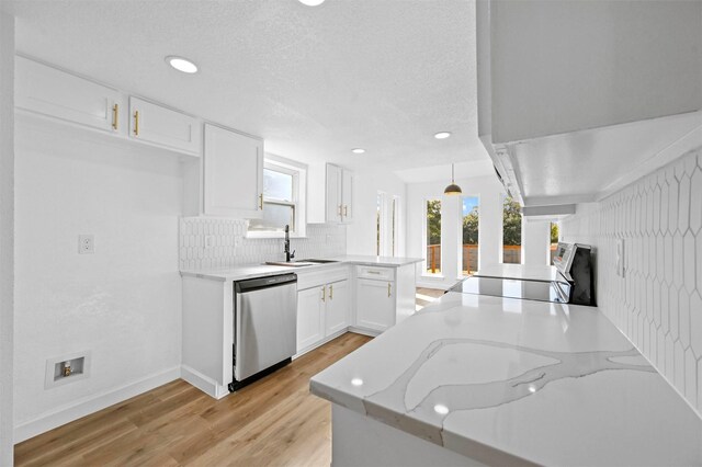 kitchen with dishwasher, hanging light fixtures, light stone counters, kitchen peninsula, and white cabinets