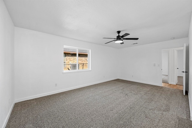 spare room with ceiling fan, carpet floors, and a textured ceiling