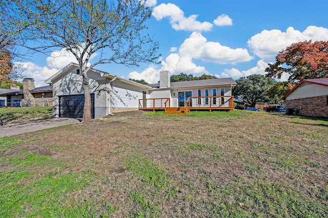 rear view of house featuring a deck and a yard