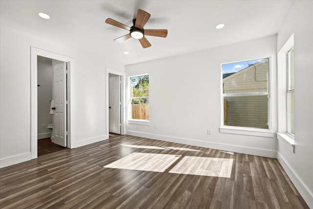 unfurnished bedroom featuring connected bathroom, ceiling fan, and dark hardwood / wood-style flooring