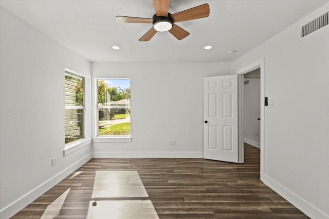 spare room featuring dark hardwood / wood-style flooring and ceiling fan