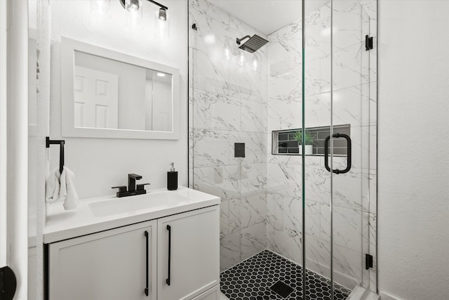 bathroom with vanity and a shower with shower door