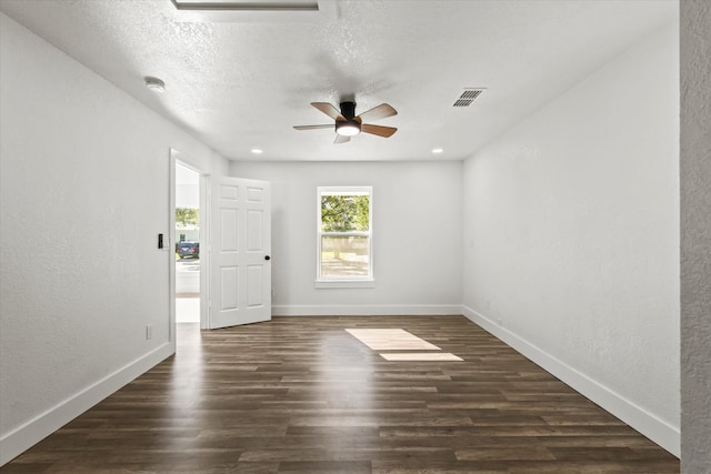 spare room featuring a textured ceiling, dark hardwood / wood-style flooring, and ceiling fan