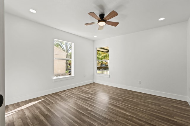 empty room featuring dark hardwood / wood-style flooring and ceiling fan