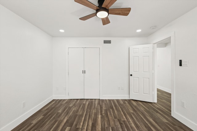 unfurnished bedroom featuring ceiling fan, a closet, and dark hardwood / wood-style floors