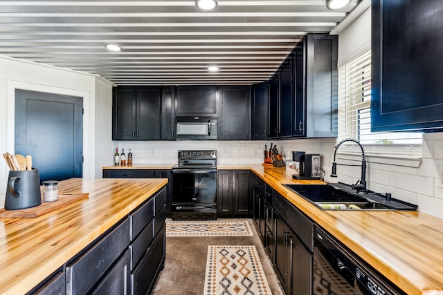 kitchen featuring wooden counters, sink, tasteful backsplash, and black appliances