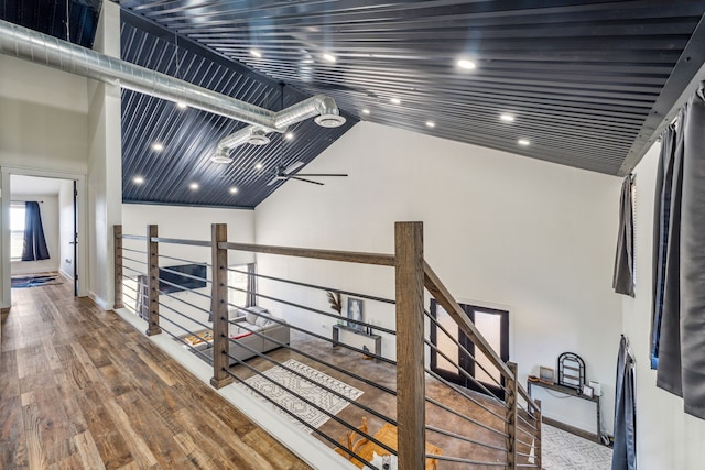 hallway with lofted ceiling, wood-type flooring, and wood ceiling