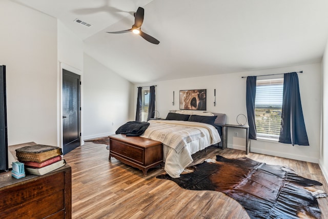 bedroom featuring ceiling fan, vaulted ceiling, and hardwood / wood-style flooring