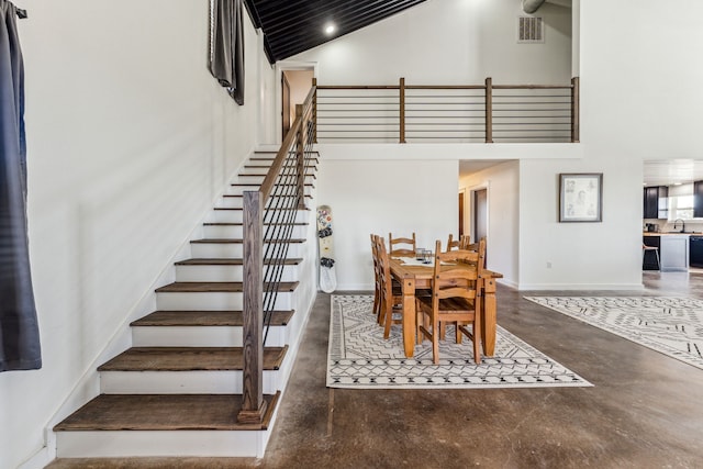 dining room with a high ceiling and sink