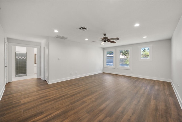 spare room featuring ceiling fan and dark hardwood / wood-style flooring