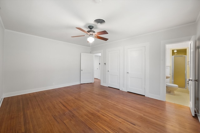 unfurnished bedroom with connected bathroom, hardwood / wood-style floors, ceiling fan, and ornamental molding