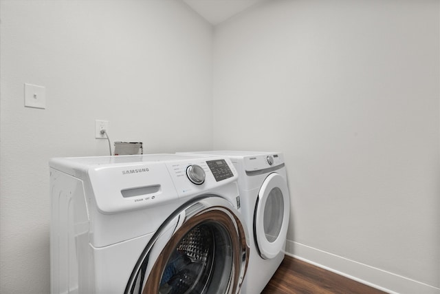 laundry area with washing machine and dryer and dark hardwood / wood-style floors