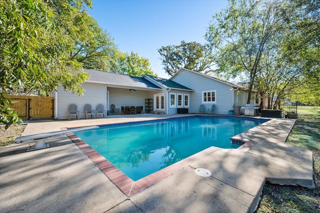 view of swimming pool with french doors, a patio, and ceiling fan