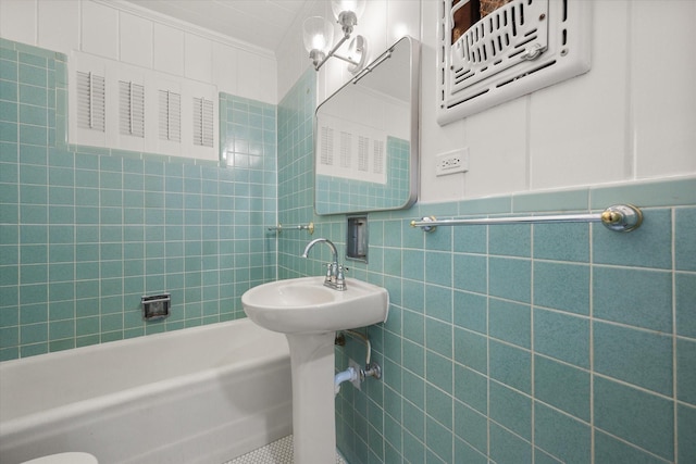 bathroom with tile walls and crown molding