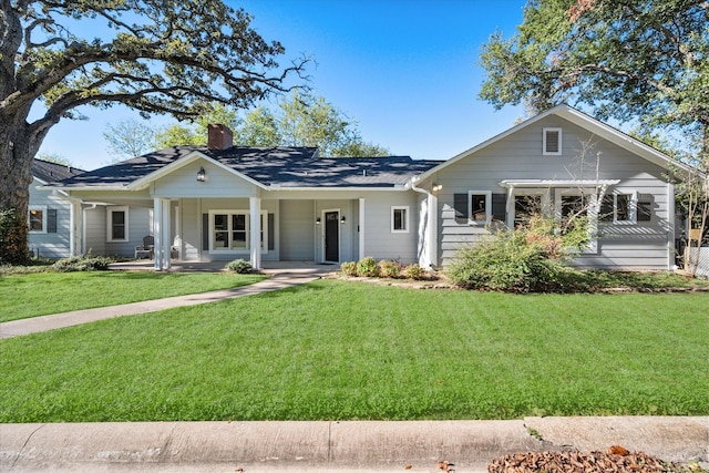 single story home with a porch and a front lawn