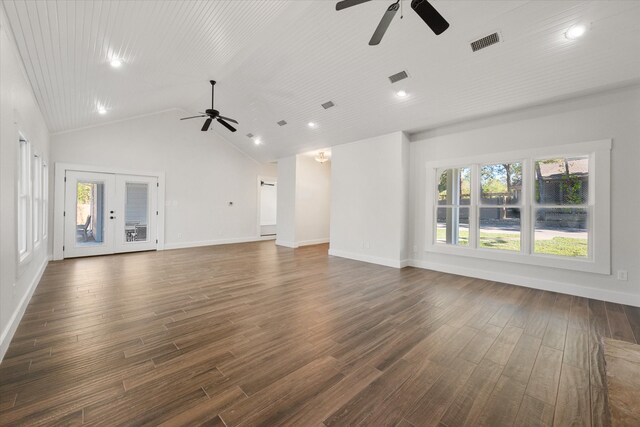 unfurnished living room with high vaulted ceiling, french doors, a wealth of natural light, and dark hardwood / wood-style floors