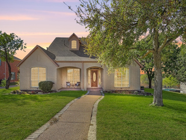 view of front of property with a lawn and covered porch