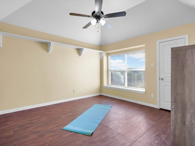 interior space with ceiling fan, dark hardwood / wood-style flooring, and lofted ceiling