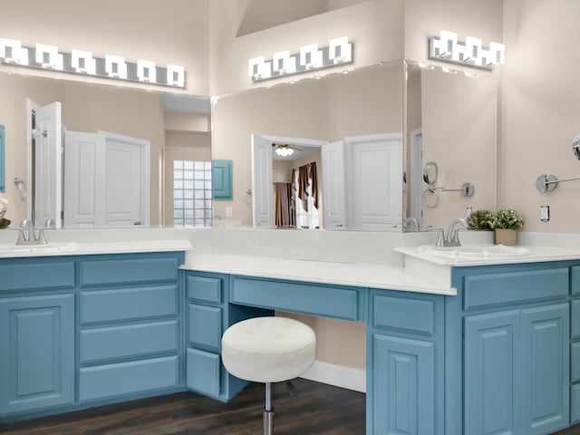 bathroom with hardwood / wood-style floors, vanity, and ceiling fan