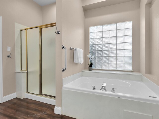 bathroom featuring wood-type flooring and independent shower and bath