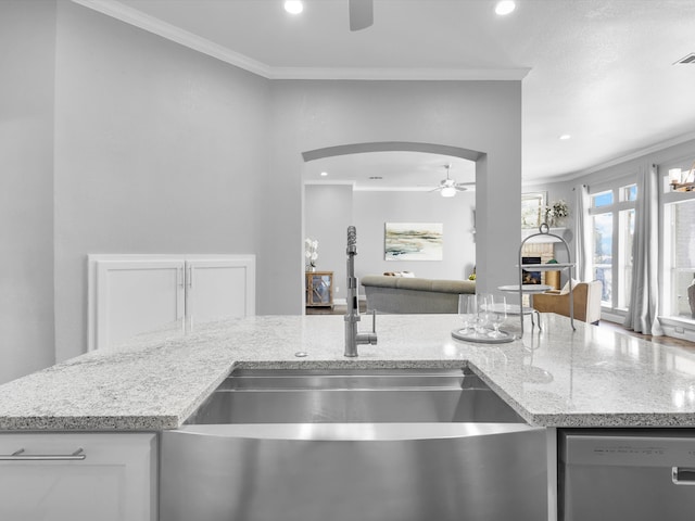 kitchen with dishwasher, light stone countertops, and ornamental molding