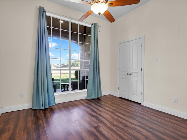 spare room featuring ceiling fan and dark wood-type flooring