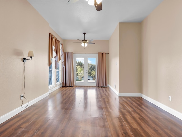 unfurnished living room featuring french doors, dark hardwood / wood-style floors, and ceiling fan