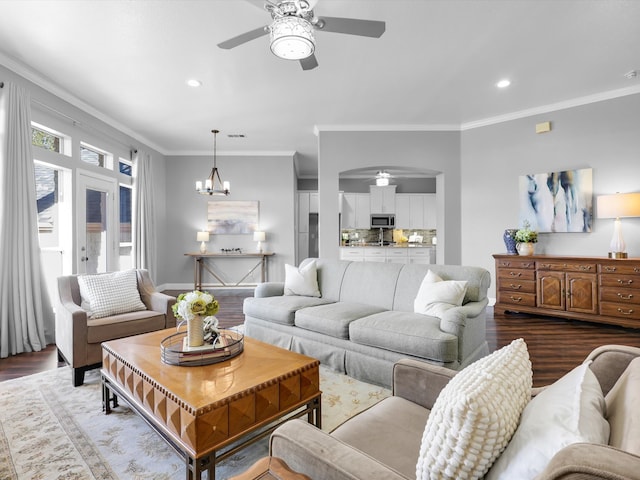 living room featuring a chandelier, light hardwood / wood-style flooring, and crown molding