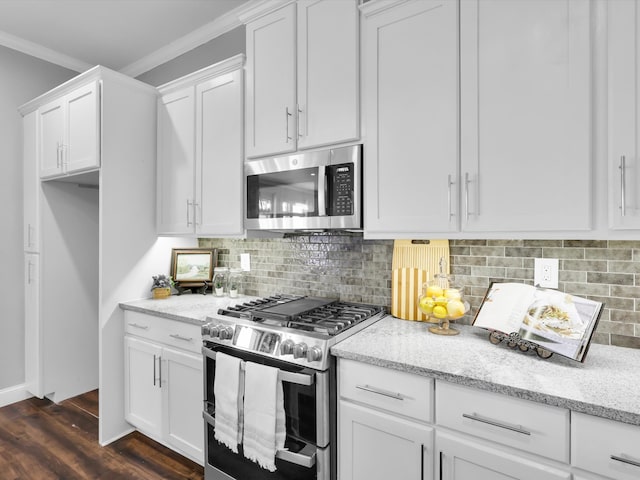 kitchen featuring light stone countertops, ornamental molding, stainless steel appliances, dark hardwood / wood-style floors, and white cabinetry